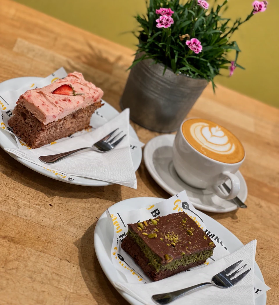 A pink iced cake with coffee